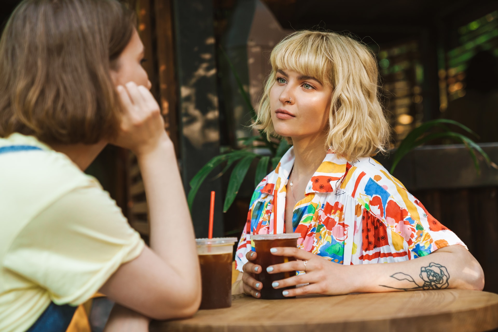 Two friends having a conversation at a cafe